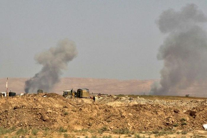 Smoke billows as Iraqi forces, backed by Shiite fighters from the Popular Mobilisation Forces, advance towards the city of Tal Afar, a key remaining stronghold of the Islamic State group, on August 21, 2017