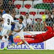 Uruguay's goalkeeper Fernando Muslera (R) jumps to save the ball as Uruguay's defender Jose Maria Gimenez (not pictured) scores an own goal during the friendly football match Italy vs Uruguay, a fumble that helped Italy achieve victory