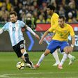 Argentina’s Lionel Messi (L) fights for the ball with Brazil’s Renato Augusto (R) during their friendly international football match between Brazil and Argentina at the MCG in Melbourne