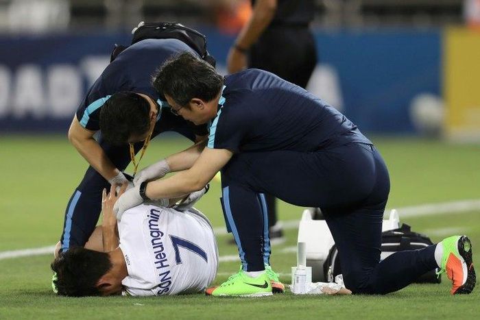 South Korea's Son Heung-Min receives medical treatment during the World Cup qualifier against Qatar in Doha on June 13, 2017