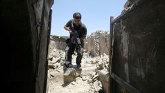 A member of the Iraqi Counter-Terrorism Service secures a building in the old quarter of Mosul, which a coalition general says will be free of Islamic State group fighters by next week