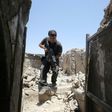 A member of the Iraqi Counter-Terrorism Service secures a building in the old quarter of Mosul, which a coalition general says will be free of Islamic State group fighters by next week