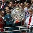 Arsenal's manager Arsene Wenger (R) and goalkeeper Petr Cech (L) hold up the trophy as they celebrate after their victory in the English FA Community Shield football match on August 6, 2017