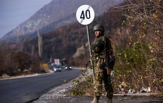 A soldier of the NATO-led peacekeeping mission in Kosovo (KFOR) secures the area near the village of Rudare in northern Mitrovica during a protest of Kosovo Serbs on November 23, 2018