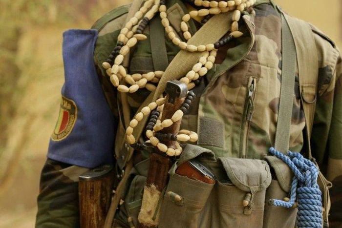A Malian soldier guards a checkpoint on the road between Gao and Kidal