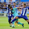 Barcelona's Lionel Messi (C) vies with Deportivo Alaves' Wakaso Mubarak (L) and Tomas Pina (R) during their match in Vitoria on August 26