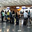 Passengers wait to check-in at the Hamad International Airport in Doha on June 7, 2017 after a ban on Qatari flights imposed by Saudi Arabia and its allies which cut ties with Doha and ordered Qataris out