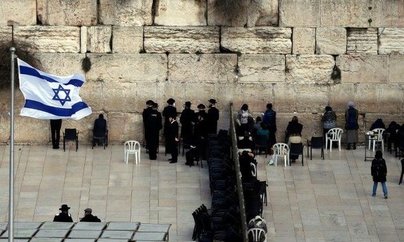 Ultra-Orthodox Jewish men (L) and women (R) pray in different sections of the Western Wall in Jerusalem's Old City on February 2, 2016