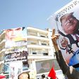 An Iranian man holds a poster bearing images of Israeli Prime Minister Benjamin Netanyahu, US President Donald Trump and Saudi King Salman during a parade. Trump had described a 2015 nuclear accord with Iran as "the worst deal ever" and accused Iran of...