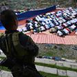A member of the police special action force stands guard as Muslims, who fled the conflict in Marawi, pray during Eid al-Fitr in Iligan City on the southern island of Mindanao