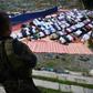 A member of the police special action force stands guard as Muslims, who fled the conflict in Marawi, pray during Eid al-Fitr in Iligan City on the southern island of Mindanao