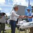 Colombian President Juan Manuel Santos shakes hands with a UN observer before closing the last container with weapons surrendered by the Revolutionary Armed Forces of Colombia (FARC) in a ceremony that brought the country's 50 year war to a final end
