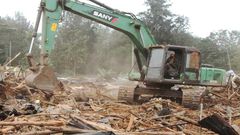 A bulldozer demolishing a building