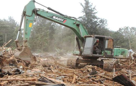 A bulldozer demolishing a building