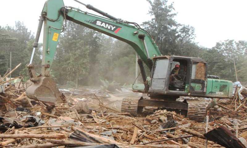 A bulldozer demolishing a building