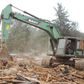 A bulldozer demolishing a building