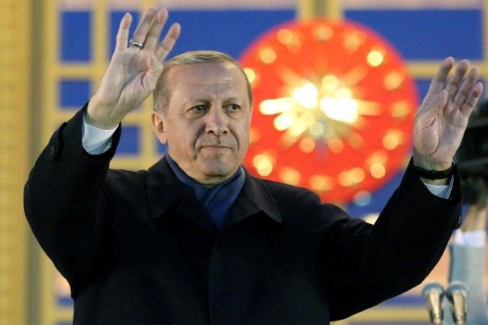 Turkish President Recep Tayyip Erdogan waves to supporters after winning a referendum that greatly enhanced his powers
