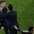 Mexico's coach Juan Carlos Osorio (L) is held back during a 2017 Confederations Cup football match between Mexico and New Zealand at the Fisht Stadium in Sochi, after Osorio lost his temper during an argument with a New Zealand assistant coach