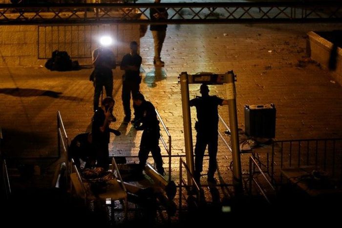 Israeli security forces take down security barriers at the Lions' Gate, a main entrance to the Al-Aqsa mosque compound in Jerusalem's Old City, on July 24, 2017