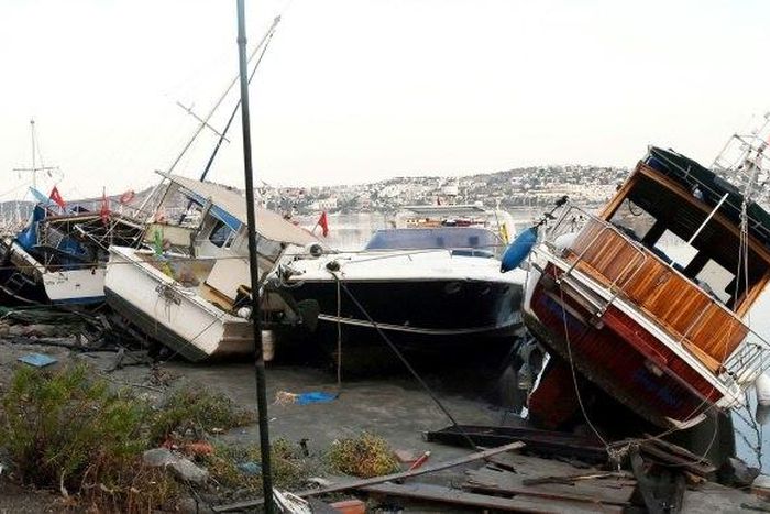 The quake triggered a mini tsunami which damaged boats and vehicles