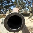 An Israeli soldier carries a shell as he and his comrades prepare their Merkava tanks stationed on the border between Israel and the Gaza Strip on July 31, 2014