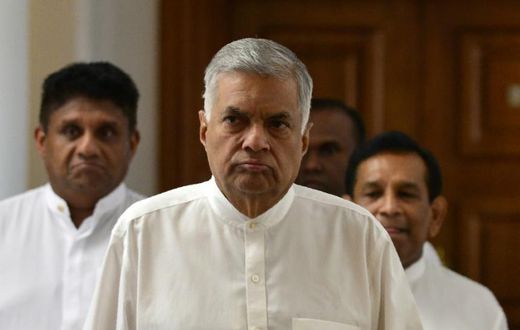 Sri Lanka's ousted premier Ranil Wickremesinghe (C) has refused to vacate the prime minister's official residence since his dismissal in October