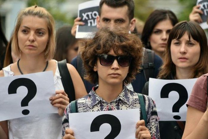 People carry signs during a march in central Kiev on July 20, 2017 to commemorate the death of investigative journalist Pavel Sheremet