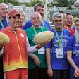 Turkmen President Gurbanguly Berdymukhamedov, surrounded by officials and participants of the upcoming 2017 Asian Indoor and Martial Arts Games, poses with melons during Melon Day celebrations in Ashgabat