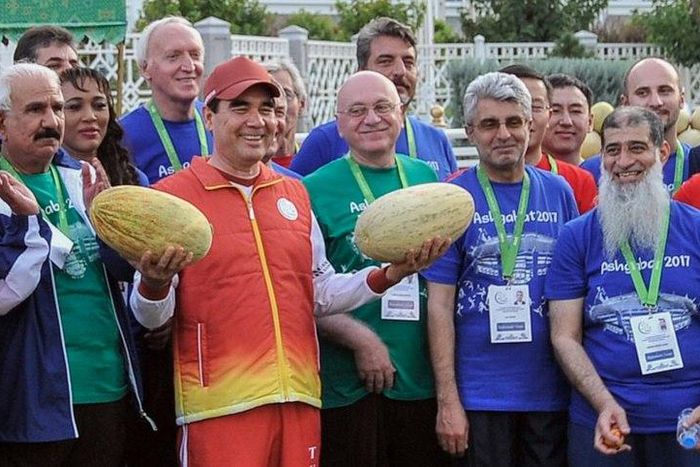 Turkmen President Gurbanguly Berdymukhamedov, surrounded by officials and participants of the upcoming 2017 Asian Indoor and Martial Arts Games, poses with melons during Melon Day celebrations in Ashgabat