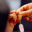 Customers buy gold earrings at a jewelry shop in Kuala Lumpur, April 17, 2013.