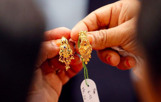 Customers buy gold earrings at a jewelry shop in Kuala Lumpur, April 17, 2013.