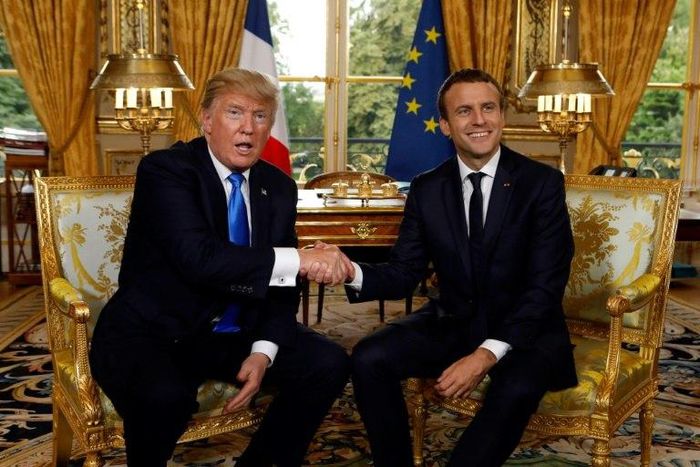 US President Donald Trump and French President Emmanuel Macron shake hands during their meeting at the Elysee Palace in Paris on July 13, 2017