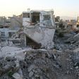 Syrian children play amidst the debris of buildings in the rebel-held town of al-Nashabiyah in the Eastern Ghouta region