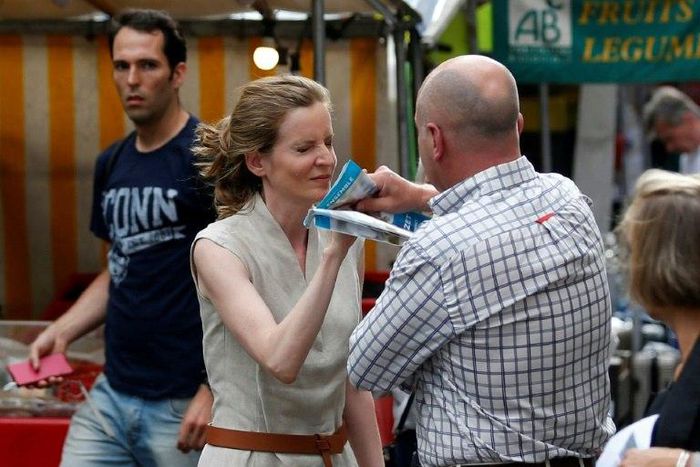 A passerby, who has been identified as Vincent Debraize, mayor of Champignolles, takes leaflets from the hand of Les Republicains (LR) party candidate Nathalie Kosciusko-Morizet during an altercation while campaigning in Paris on June 15, 2017