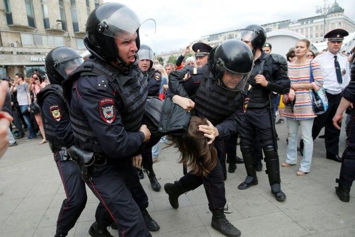 Russian police officers detain participants of an unauthorized opposition rally in Tverskaya street in central Moscow on June 12, 2017