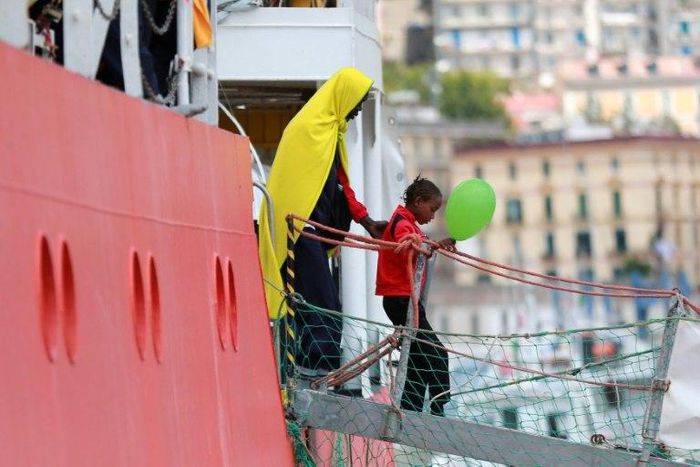 A girl disembarks from the Aquarius rescue ship run by NGO S.O.S. Mediterranee and Medecins Sans Frontieres in the Italian port of Salerno on May 26 2017 after a rescue operation in the Mediterranean