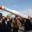 Iranians take pictures of the Simorgh satellite rocket during celebrations in Tehran to mark the 37th anniversary of the Islamic revolution on February 11, 2016