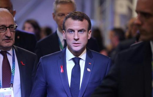The violent street protests in Paris have raised questions abroad if President Emmanuel Macron (C) is still able to reform France - let alone the European Union