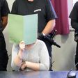 Defendant Xenia I covers her face in a courtroom in Dessau, Germany, on August 4 2017