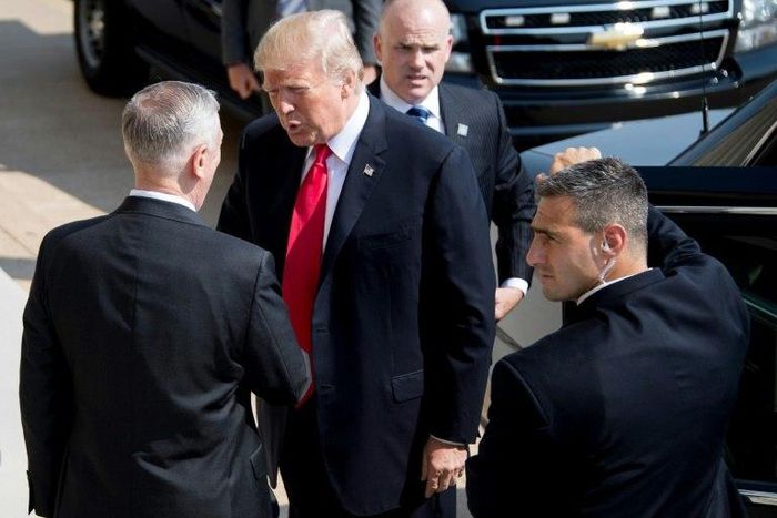 US President Donald Trump (C) shakes hands with US Defense Secretary James Mattis (L) as he arrives at the Pentagon in Washington for a strategy session on defeating IS