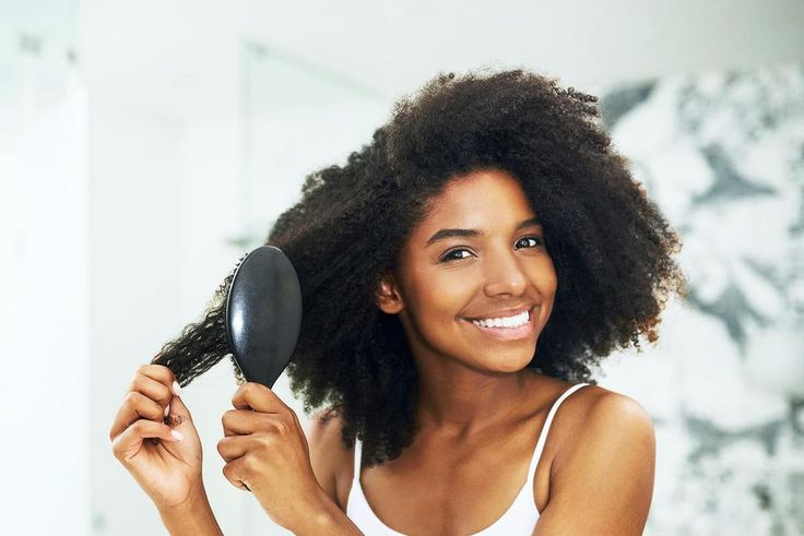 230305-1455x1098-young woman brushing her hair
