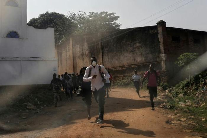 People in Beni escaped from teargas during a protest against the postponement of elections in their region