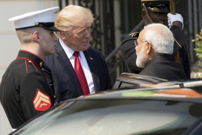 US President Donald Trump (C) and Indian Prime Minister Narendra Modi (R), shown at the White House, are seeking to solidify the relationship between their countries