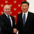 Russian President Vladimir Putin (left) shakes hands with China's President Xi Jinping during an informal meeting at the Kremlin on July 3, 2017