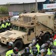 Protesters and police stand by as trailers carrying US THAAD missile defence equipment enter a deployment site in Seongju, on April 26, 2017