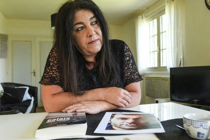 Beatrice Huret, the widow of a French police officer and a former activist of the far-right Front National party, goes on trial Tuesday for helping her Iranian migrant lover smuggle across the Channel to Britain.