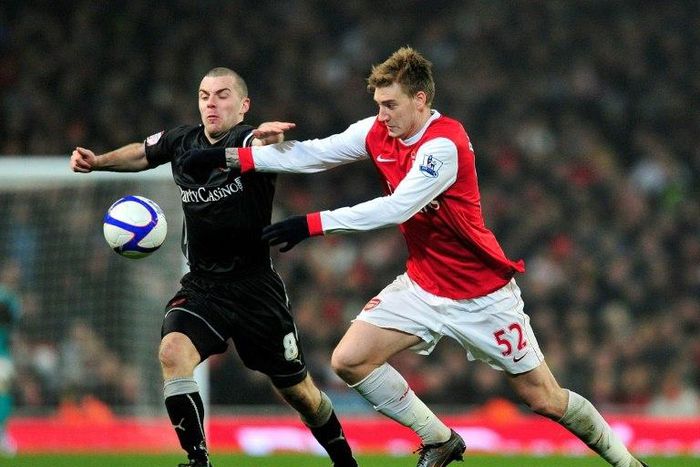 Arsenal striker Nicklas Bendtner vies with Leyton Orient's midfielder Stephen Dawson (left) during a FA Cup match at the Emirates Stadium, London on March 2, 2011