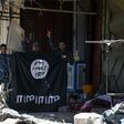 Iraqi government forces flash victory signs on June 9, 2017 while holding an Islamic State group flag in an area of western Mosul retaken from the jihadists
