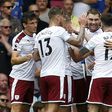 Burnley's Welsh striker Sam Vokes (C) celebrates with teammates after scoring the opening goal of the English Premier League football match between Chelsea and Burnley at Stamford Bridge in London on August 12, 2017