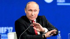 Russian President Vladimir Putin, seen here at an economic forum, tells a US television interviewer he barely spoke to former US national security advisor Michael Flynn when they met at an event in Moscow sponsored by Russian television network RT
